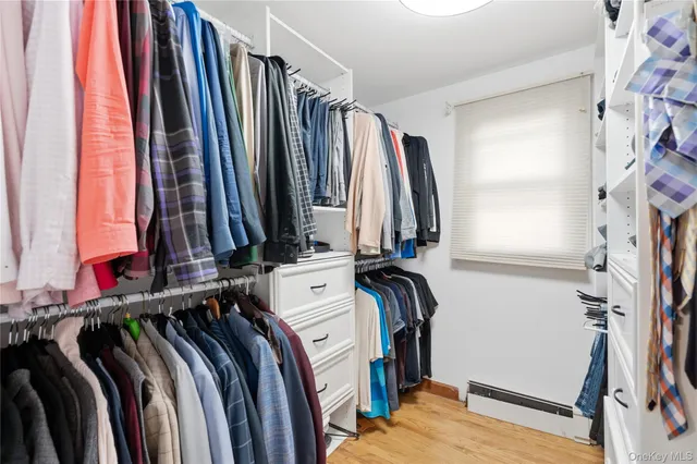 a view of walk in closet with clothes and shoes