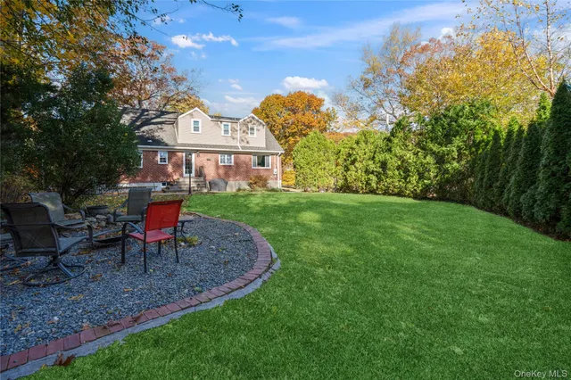 a view of a house with a yard and sitting area