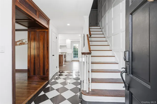 a view of entryway with wooden floor and stairs