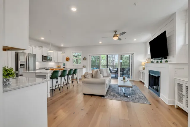 a living room with furniture a flat screen tv and a fireplace