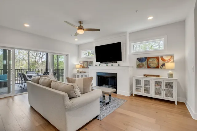 a living room with furniture a fireplace and a flat screen tv