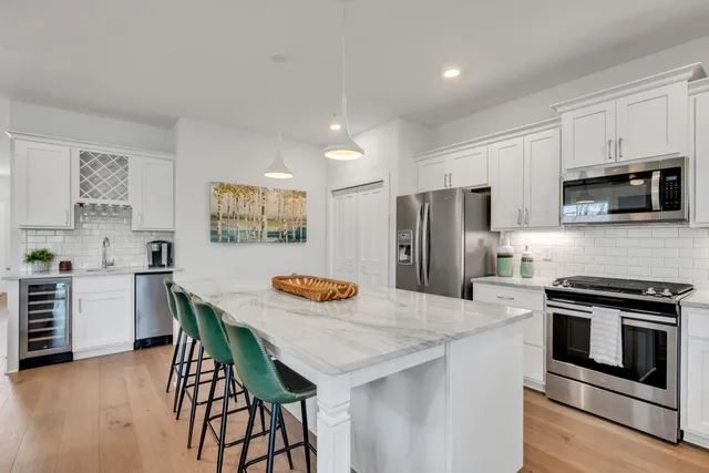 a kitchen with cabinets stainless steel appliances and a sink