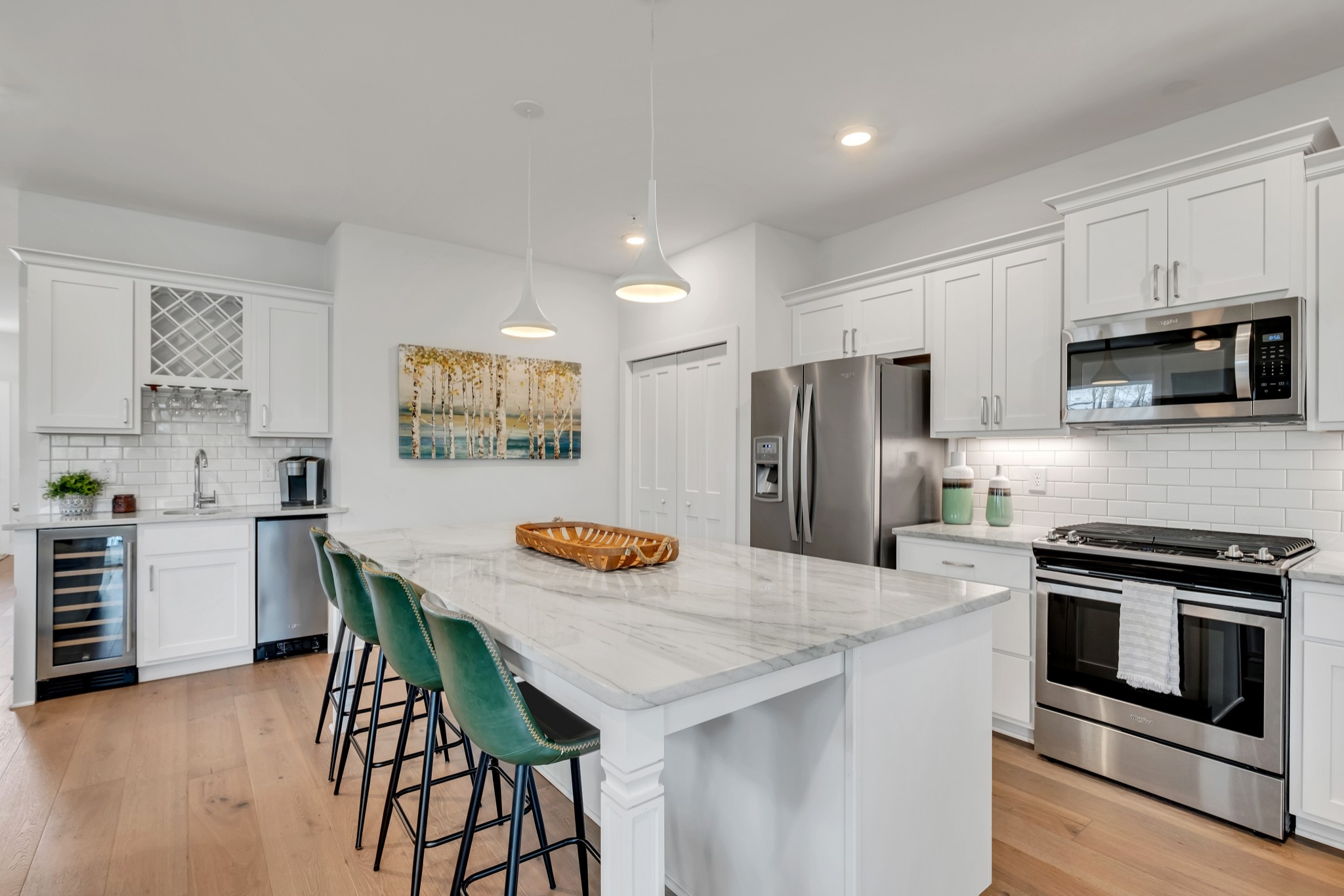 1144 Lock 4 Road, Unit F5 Gallatin, TN 37066 - Photo 17 of 40 a kitchen with stainless steel appliances kitchen island granite countertop a table chairs microwave and stove top oven