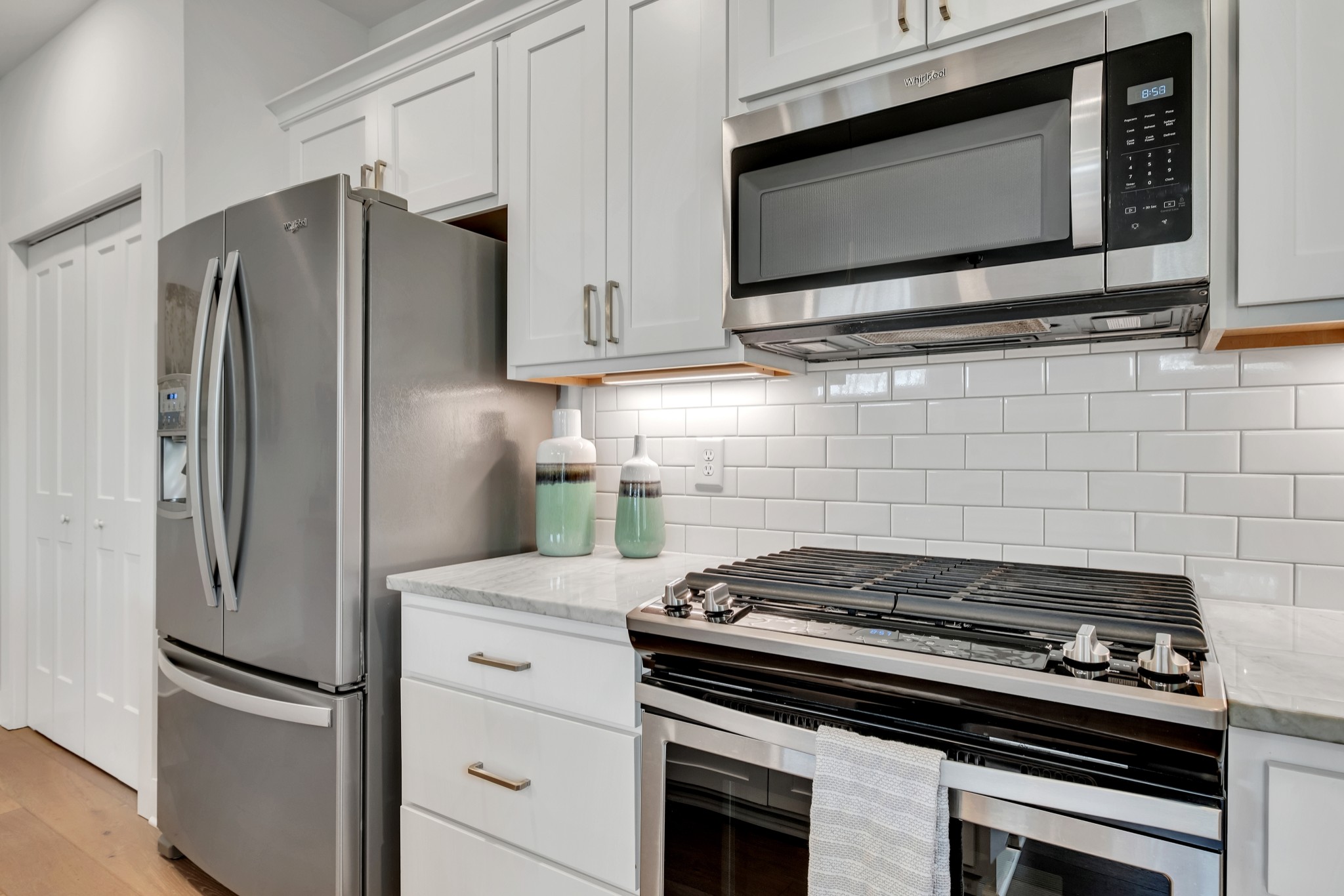 1144 Lock 4 Road, Unit F5 Gallatin, TN 37066 - Photo 19 of 40 a kitchen with stainless steel appliances white cabinets and a stove top oven