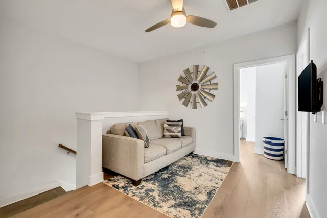 a spacious bedroom with a large bed and a chandelier