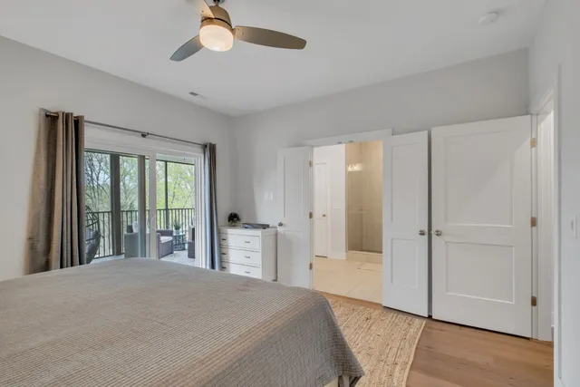 a bedroom with a large bed and a chandelier