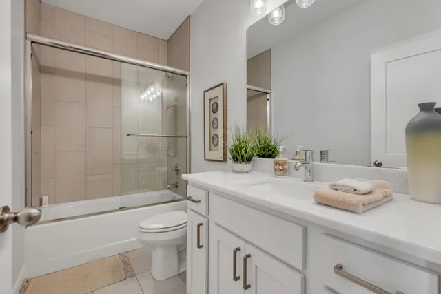 a living room with furniture and floor to ceiling windows