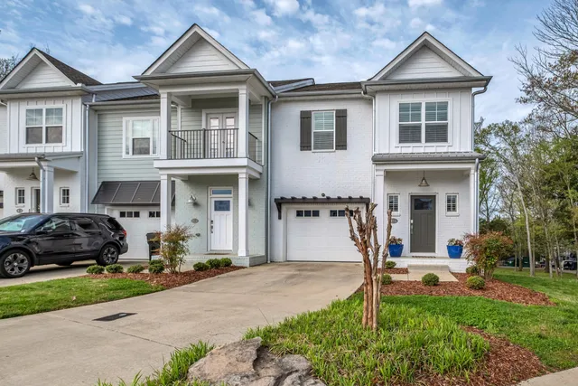 a front view of a house with a garden and porch