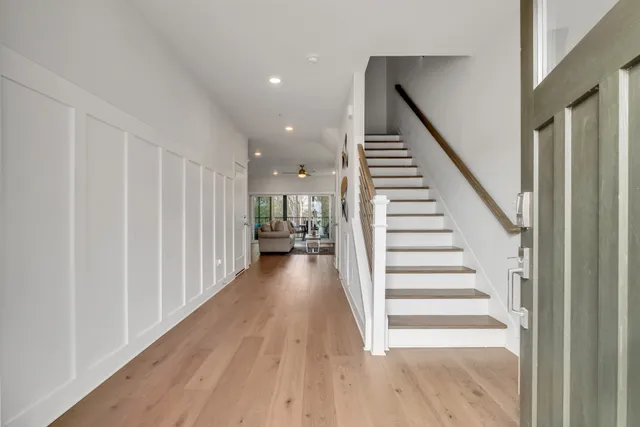 a view of a hallway with wooden floor and entryway