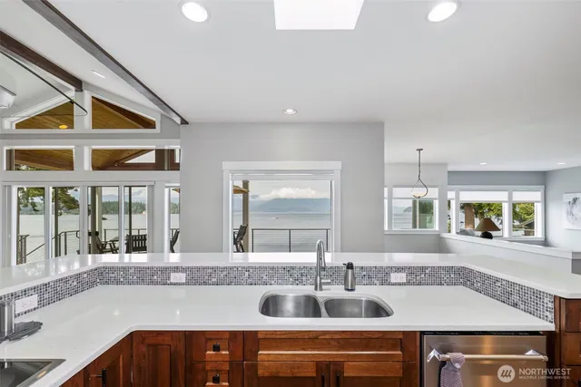 a view of a patio with wooden floor table and chairs