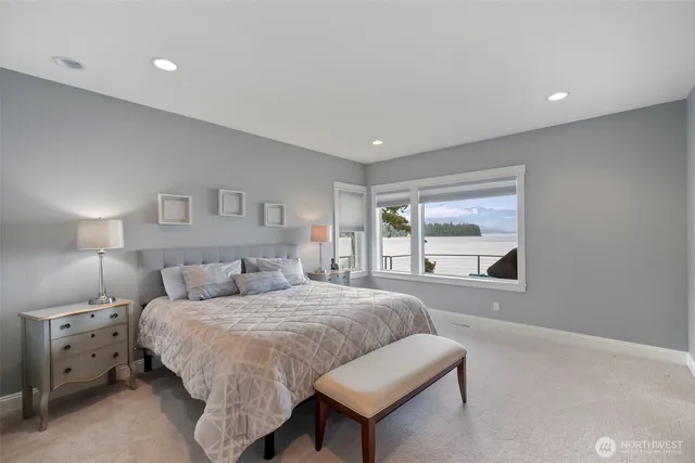 a spacious bedroom with a bed and a window