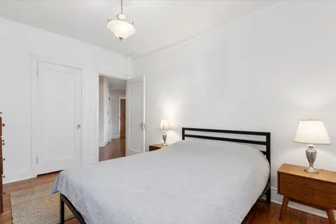 a bedroom with a bed and a lamp