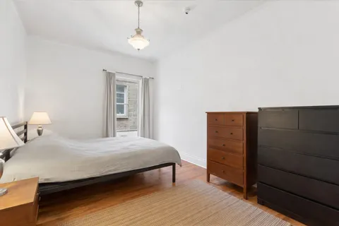 a bedroom with a bed and a dresser