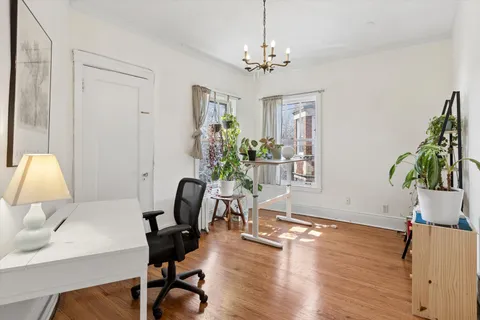 a view of a workspace with furniture and a chandelier