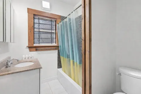 a bathroom with a granite countertop sink and a mirror