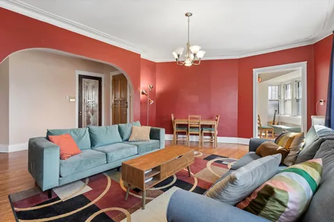 a living room with furniture chandelier and a chandelier