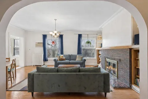 a living room with furniture and a fireplace