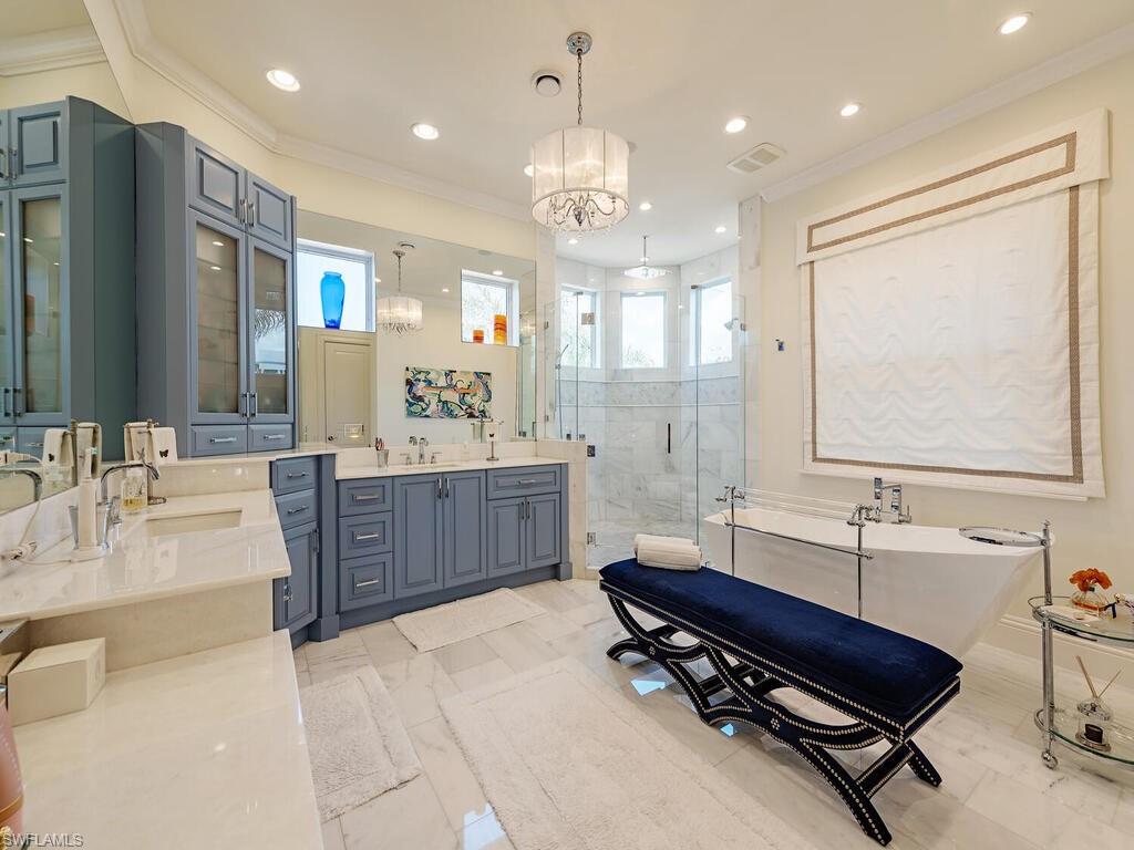 140 Conners Avenue Naples, FL 34108 - Photo 8 of 10 Full bath featuring a freestanding tub, recessed lighting, a sink, a shower stall, and crown molding