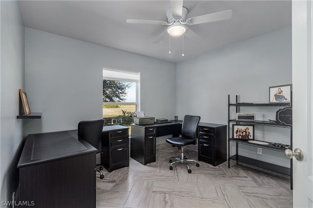 2204 Nelson Road North Cape Coral, FL 33993 - Photo 16 of 22 a view of a workspace with furniture and a window