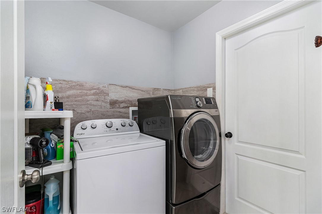 2204 Nelson Road North Cape Coral, FL 33993 - Photo 17 of 22 a utility room with dryer and washer