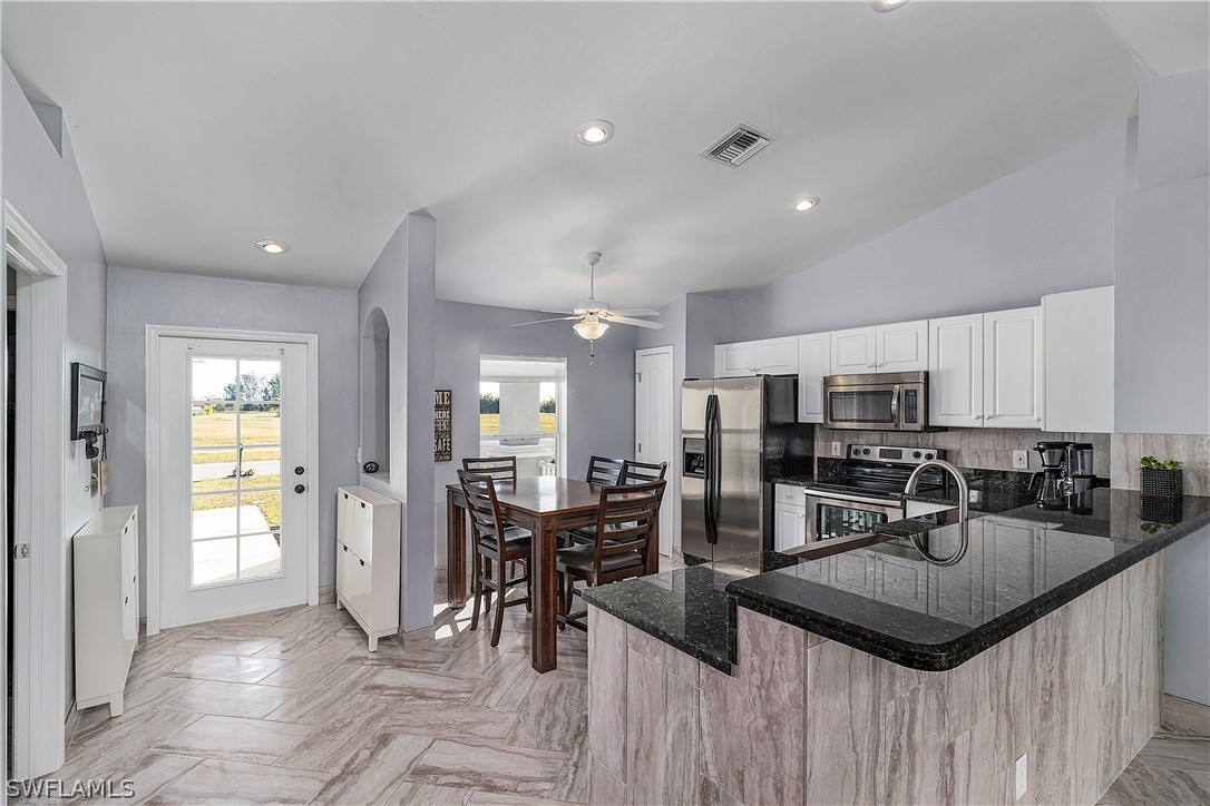 2204 Nelson Road North Cape Coral, FL 33993 - Photo 22 of 22 a kitchen with counter space cabinets and appliances
