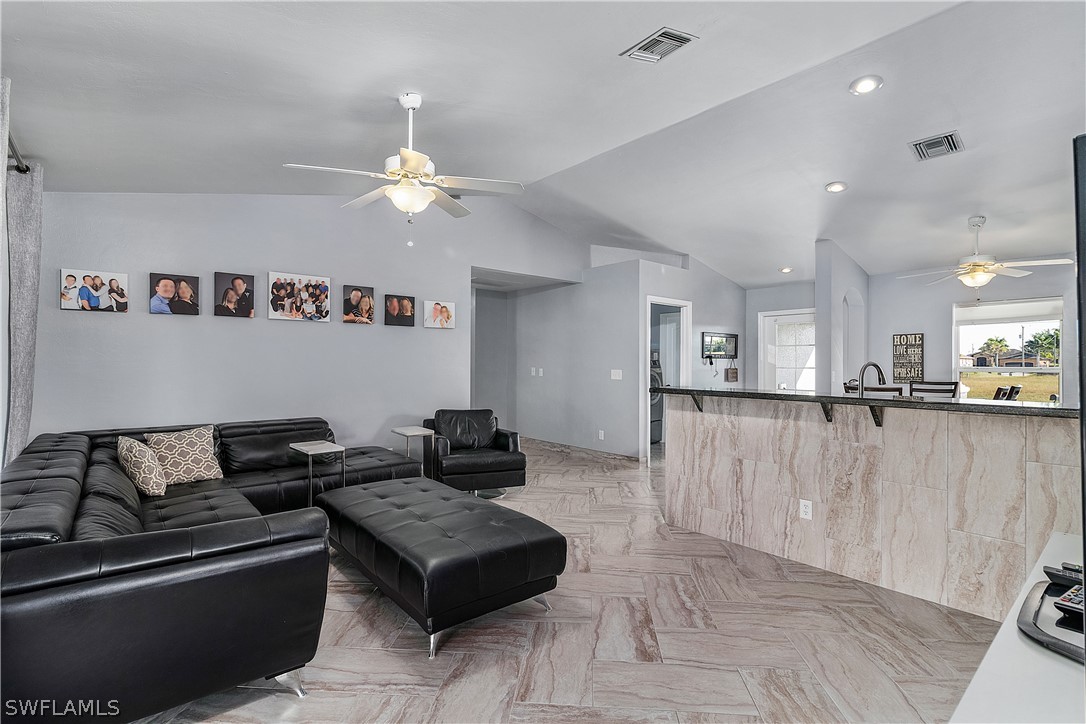 2204 Nelson Road North Cape Coral, FL 33993 - Photo 8 of 22 a living room with furniture and a chandelier