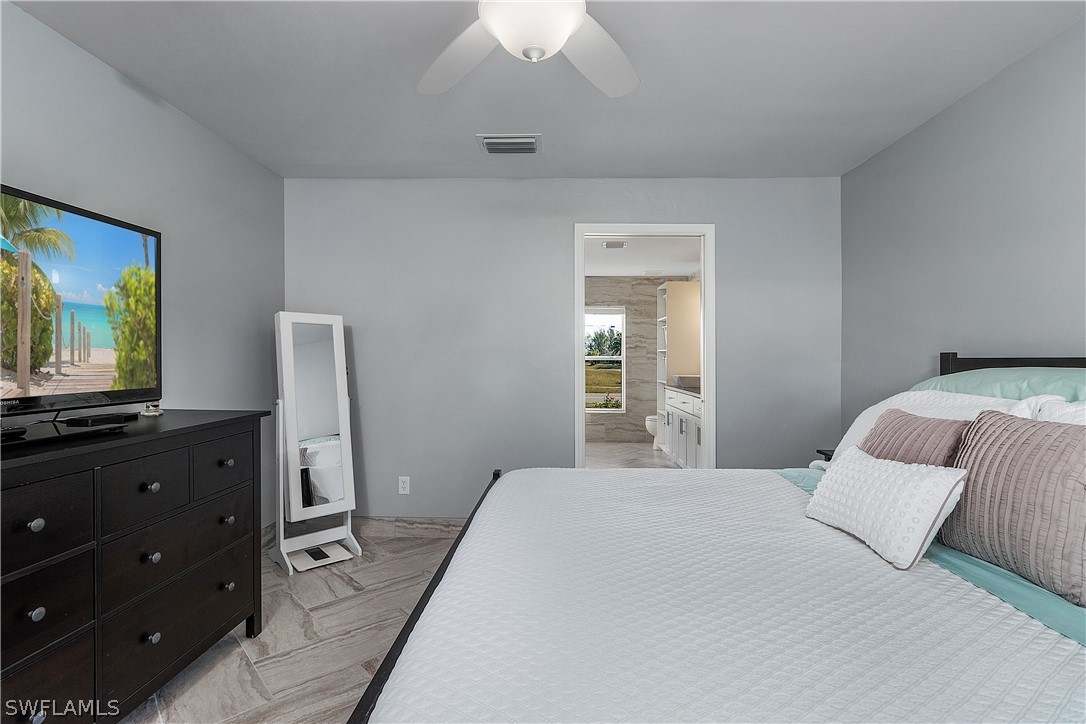 2204 Nelson Road North Cape Coral, FL 33993 - Photo 10 of 22 a bedroom with a bed and a flat screen tv