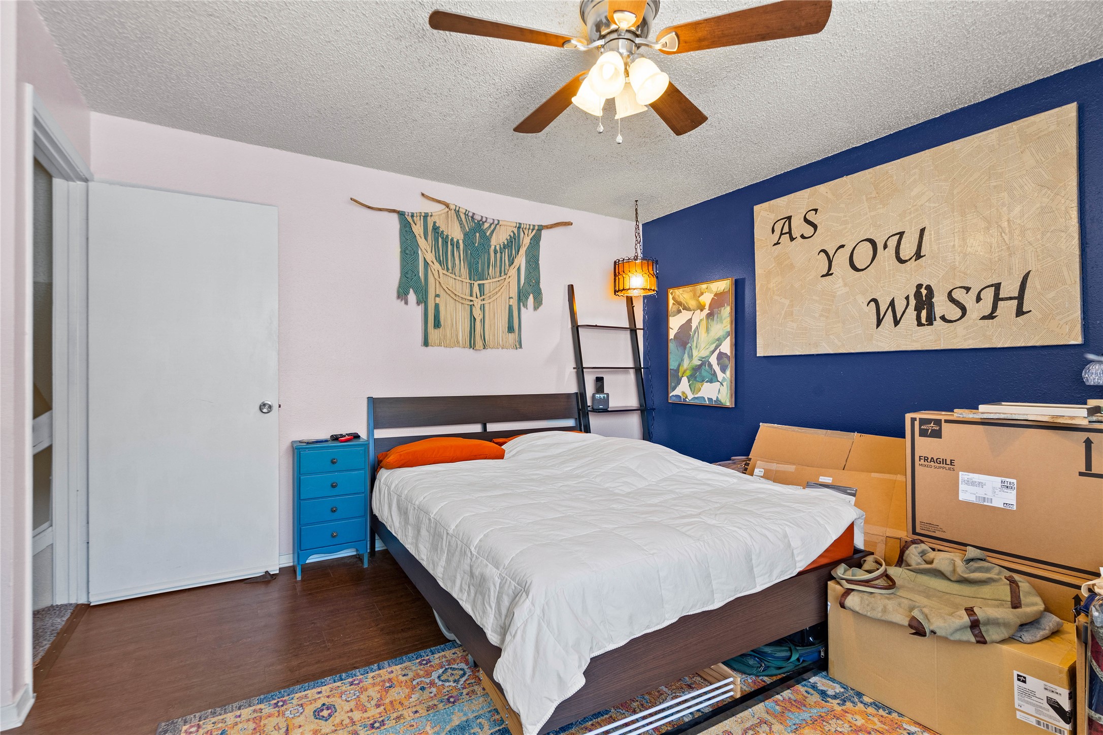 2018 West Rundberg Lane, Unit 4B Austin, TX 78758 - Photo 15 of 28 a bedroom with a bed and wooden floor