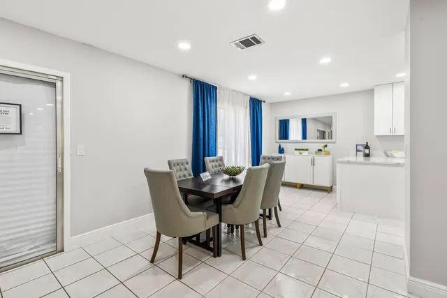 a kitchen with stainless steel appliances granite countertop a sink and a white cabinets