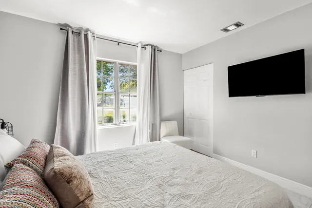 a bedroom with a bed and chair