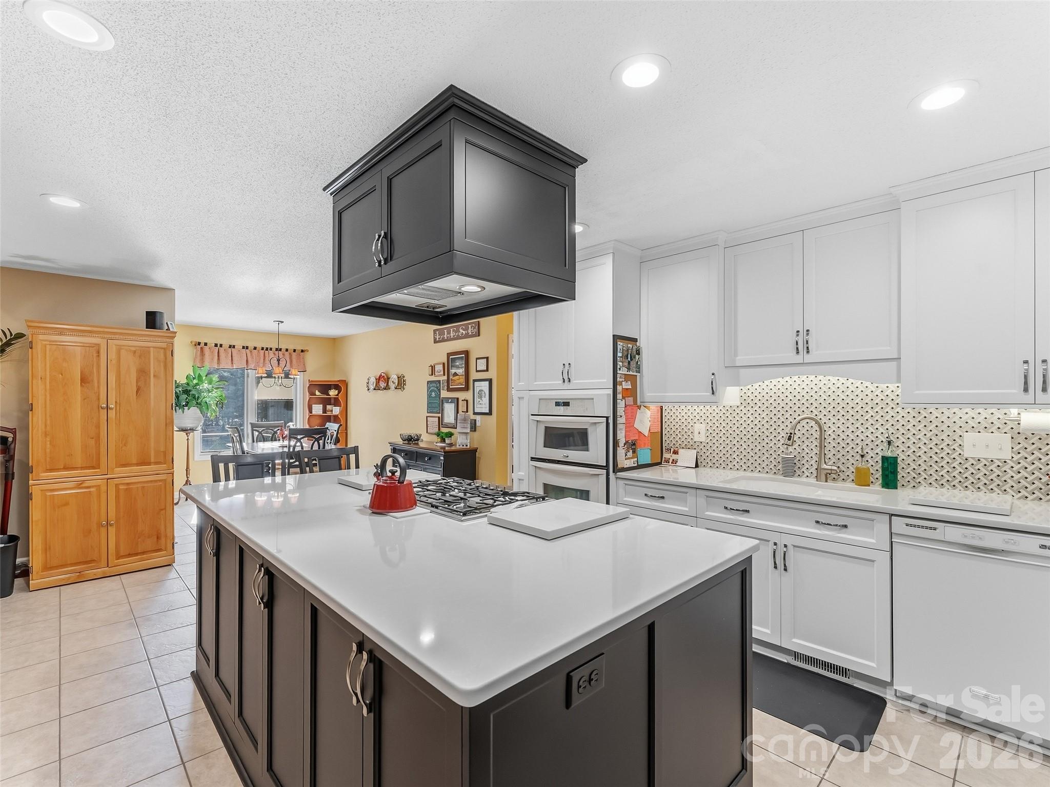 1340 Macedonia Road Saluda, NC 28773 - Photo 15 of 45 a kitchen with stainless steel appliances a sink a stove and cabinets