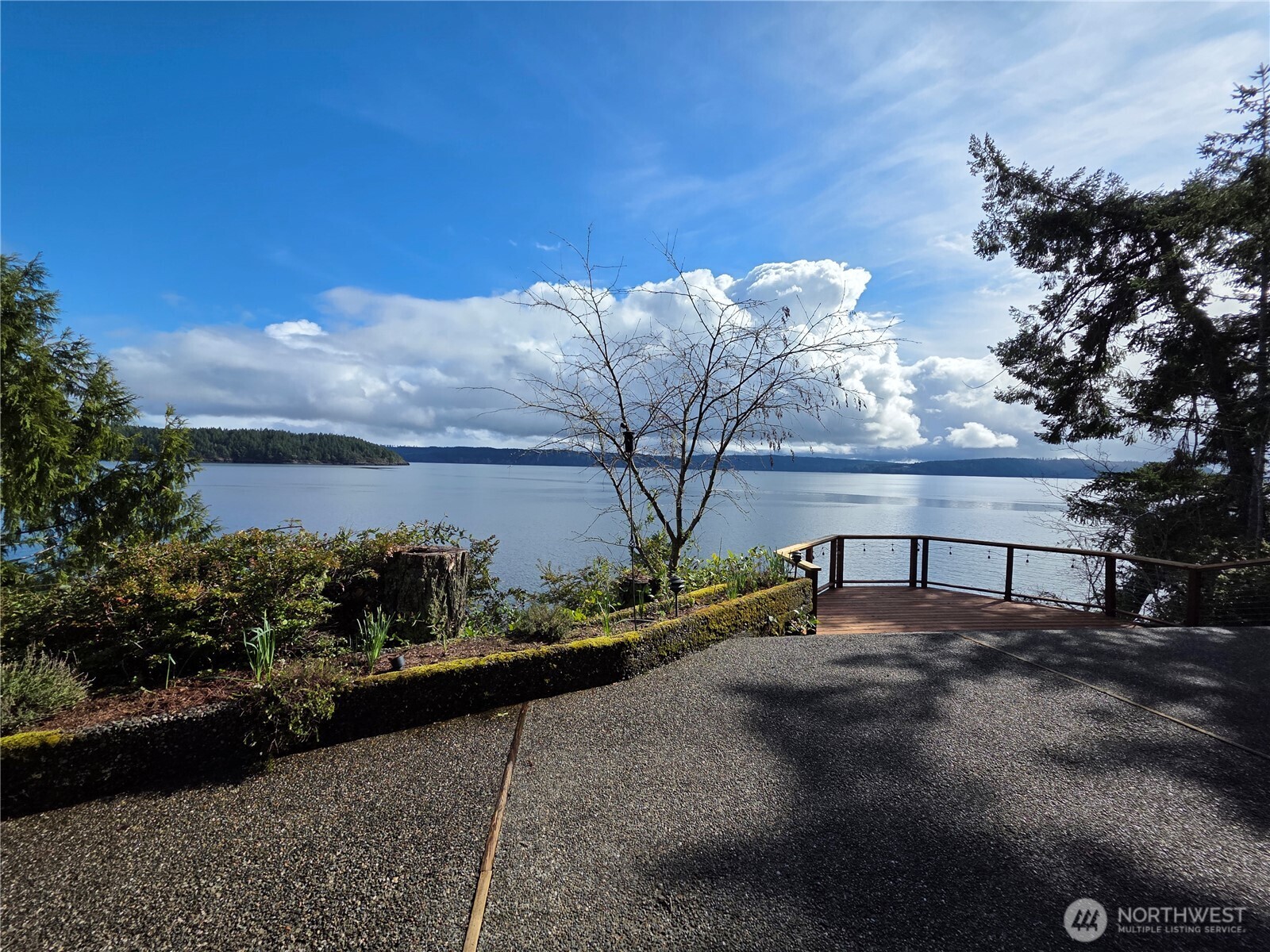 81 Wawa Point Place Brinnon, WA 98320 - Photo 1 of 37 a view of a lake with a bench in front of house