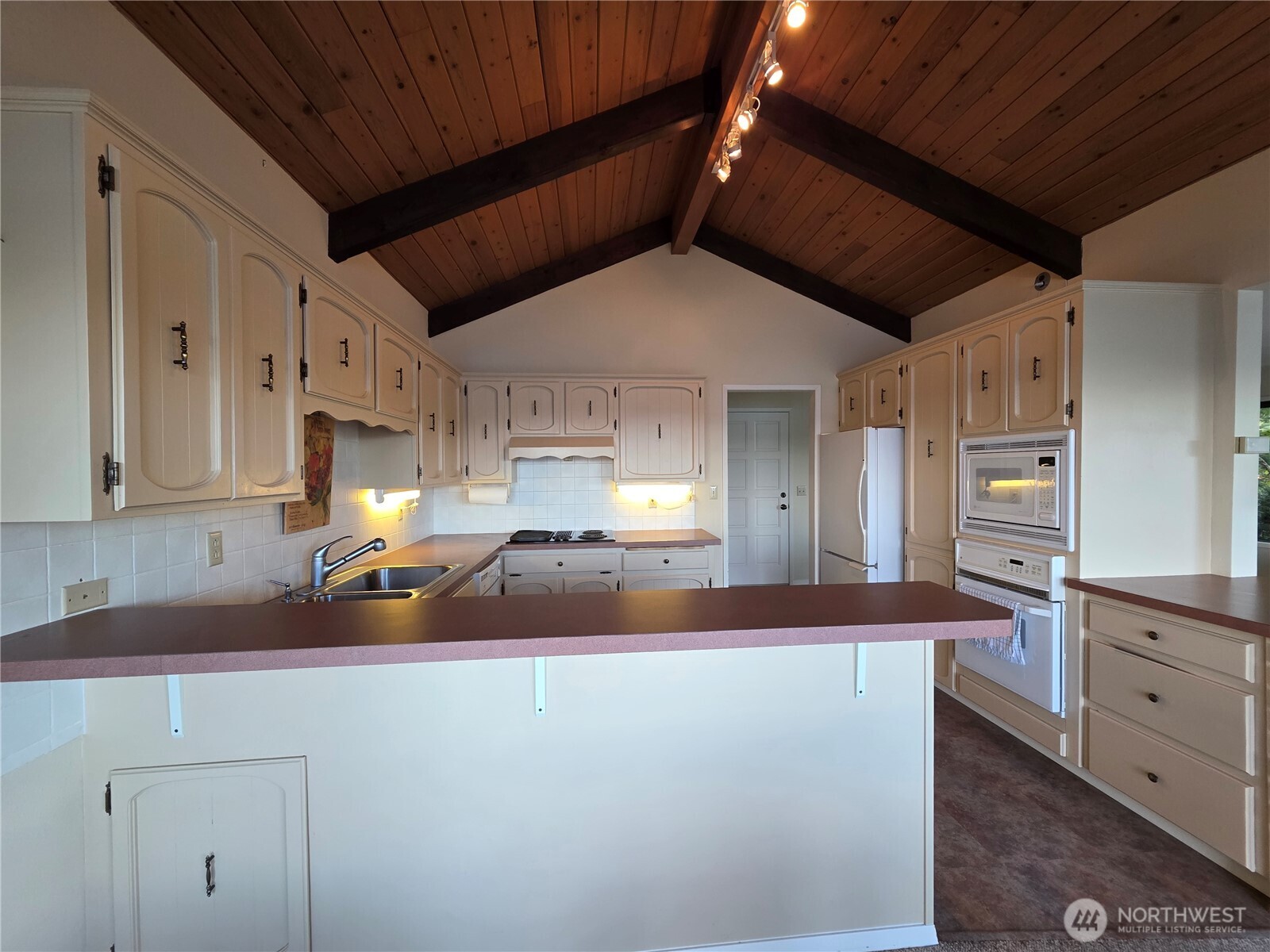 81 Wawa Point Place Brinnon, WA 98320 - Photo 11 of 37 a kitchen with kitchen island a sink stainless steel appliances and cabinets