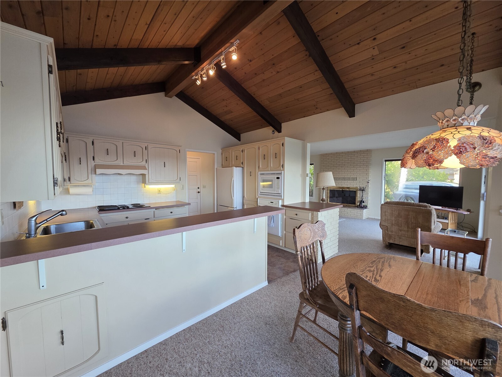 81 Wawa Point Place Brinnon, WA 98320 - Photo 13 of 37 a kitchen with stainless steel appliances granite countertop a sink table and chairs