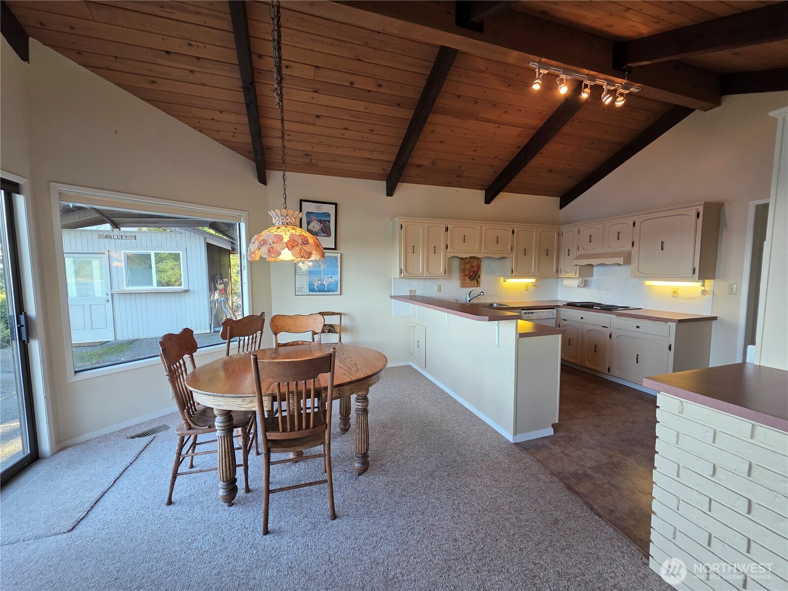 81 Wawa Point Place Brinnon, WA 98320 - Photo 15 of 37 a view of a dining room with furniture and a chandelier