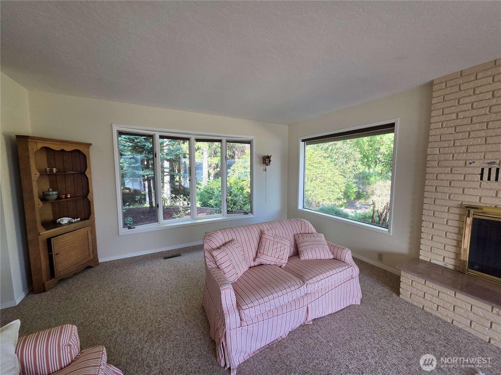 81 Wawa Point Place Brinnon, WA 98320 - Photo 17 of 37 a living room with furniture and a fireplace