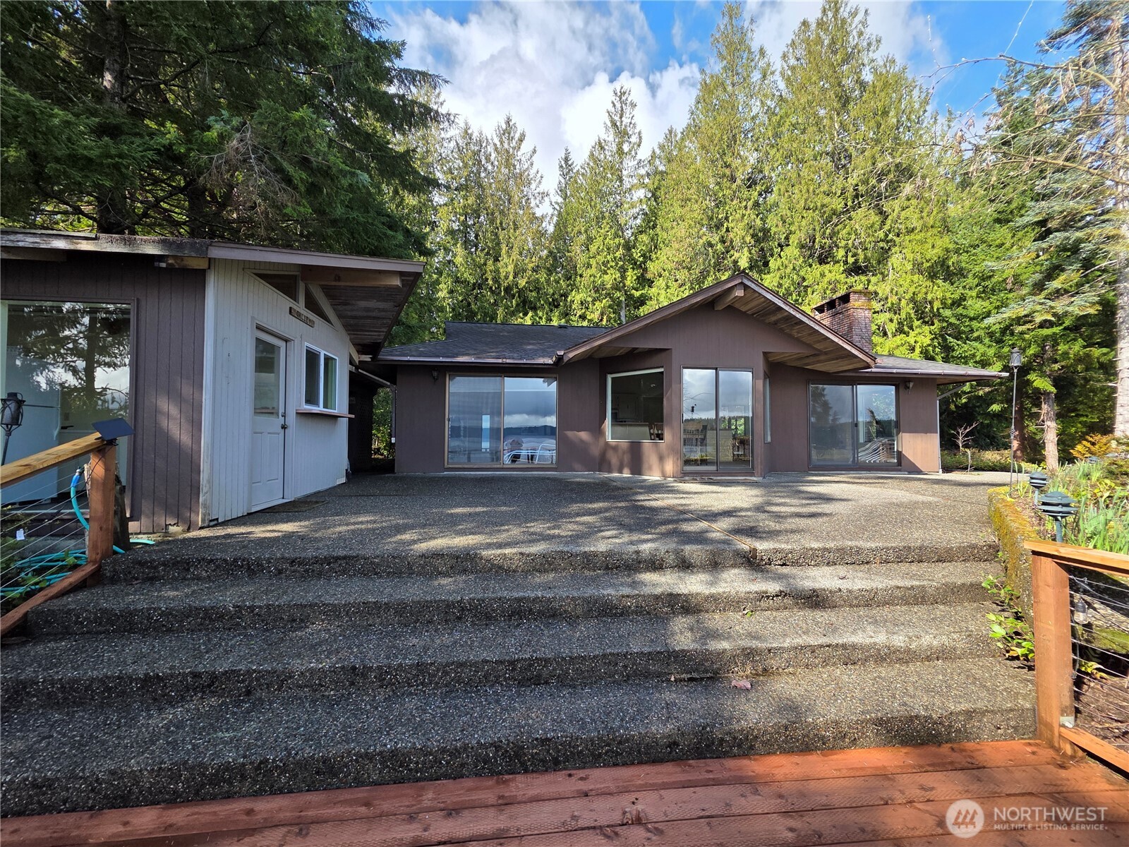 81 Wawa Point Place Brinnon, WA 98320 - Photo 2 of 37 a front view of a house with a garden