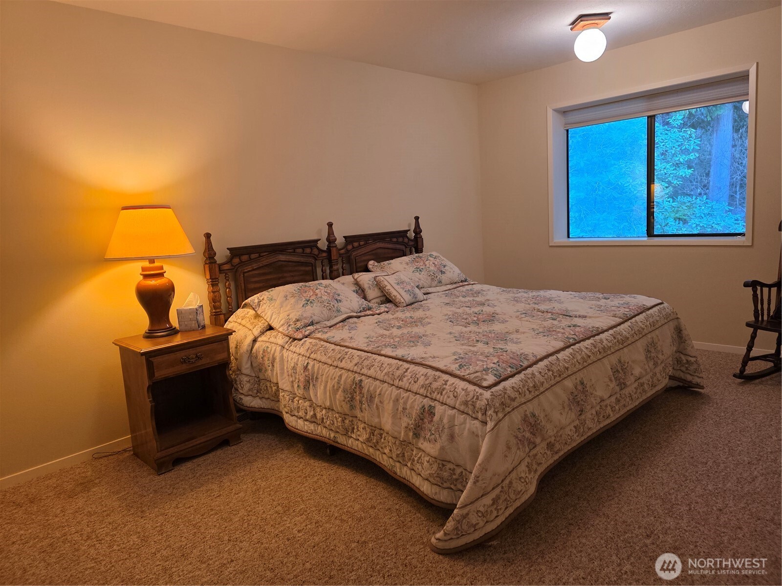 81 Wawa Point Place Brinnon, WA 98320 - Photo 24 of 37 a bed sitting in a bedroom next to a lamp