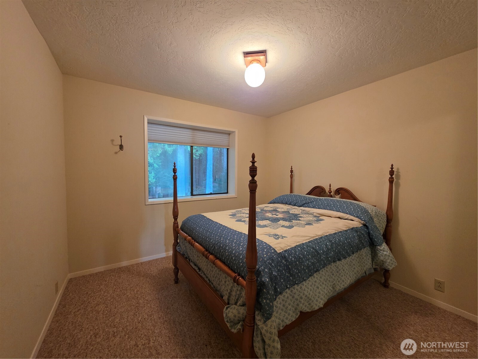 81 Wawa Point Place Brinnon, WA 98320 - Photo 26 of 37 a bed sitting in a bedroom next to a window