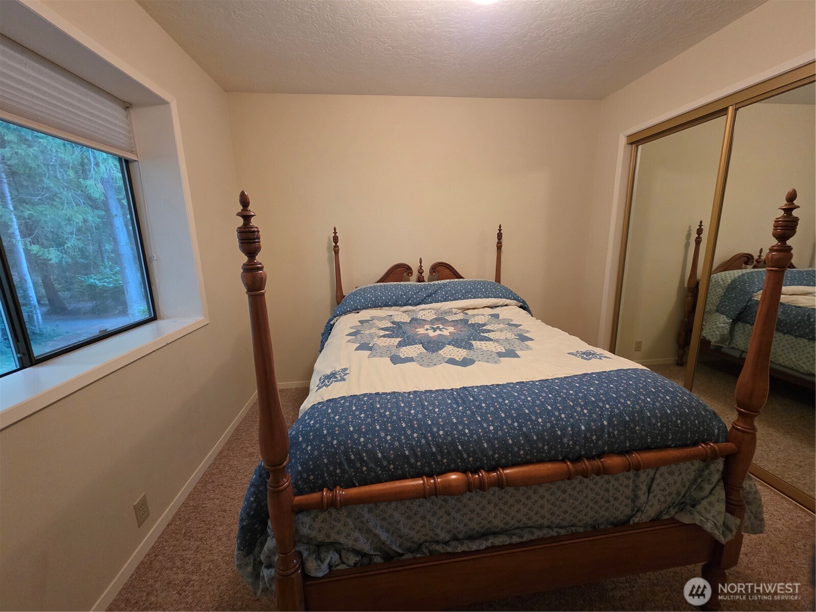 81 Wawa Point Place Brinnon, WA 98320 - Photo 27 of 37 a bedroom with a bed and a mirror