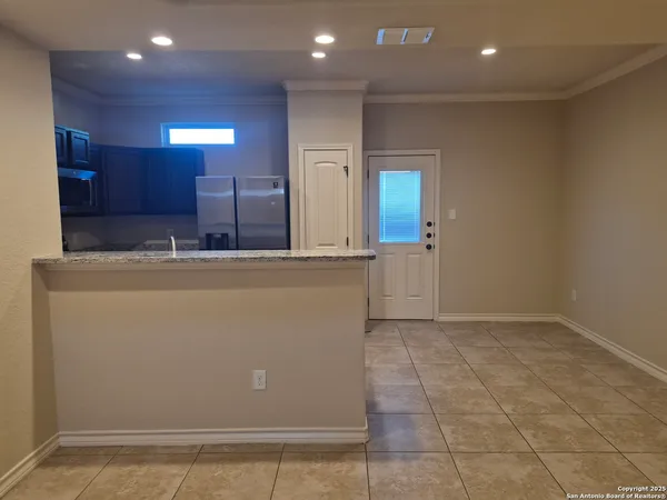 a view of a hallway with a kitchen