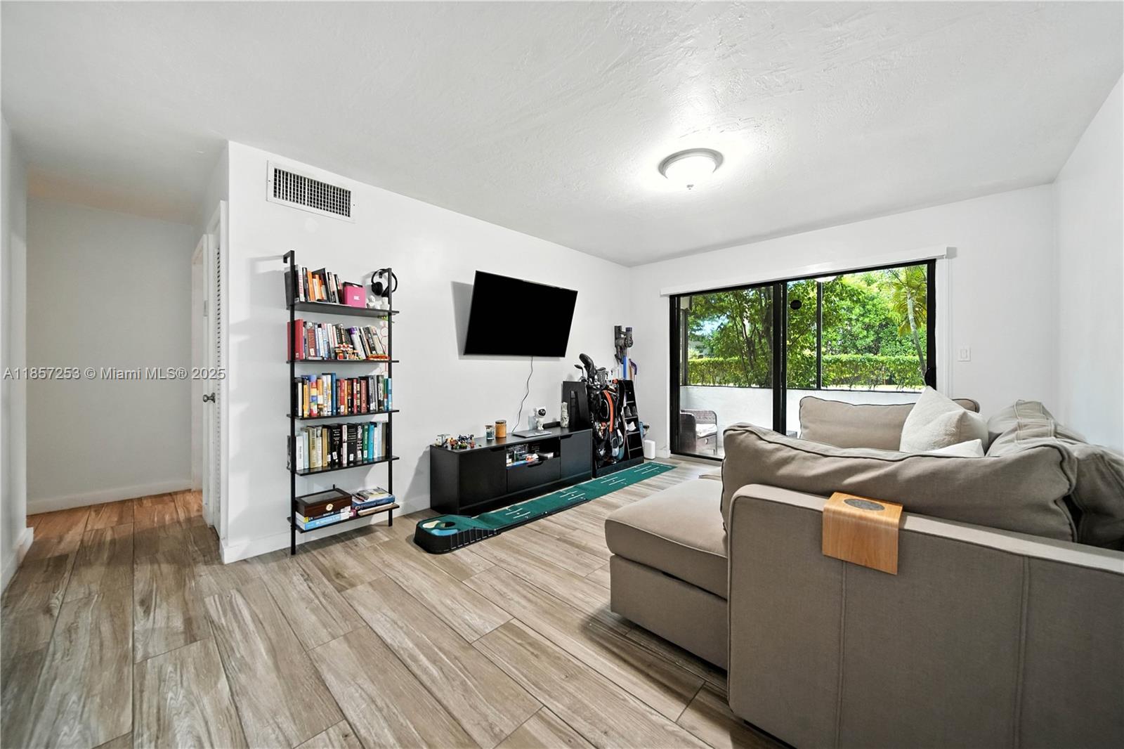 a living room with furniture window and a flat screen tv
