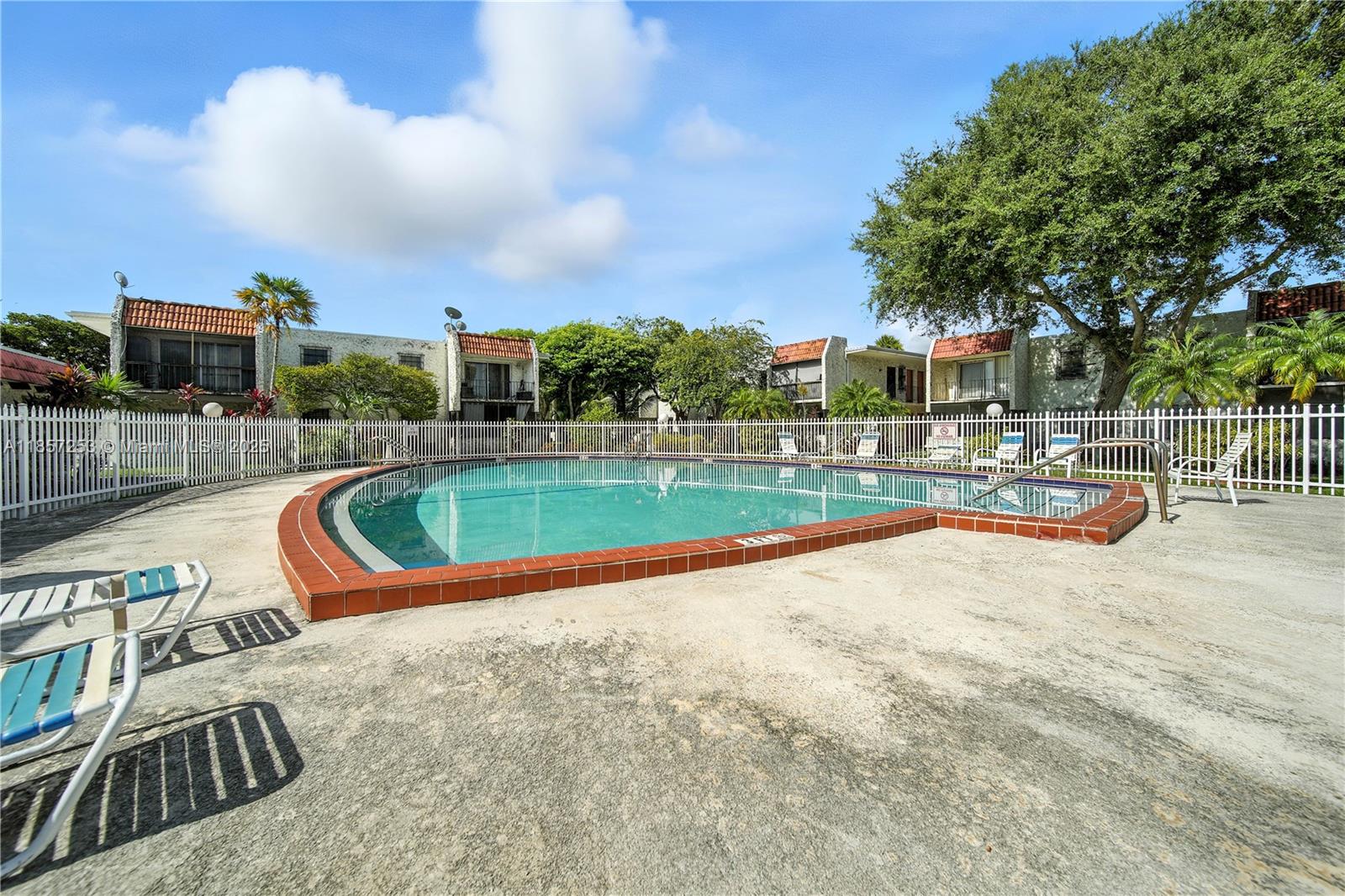 8701 Southwest 141st Street, Unit B1 Miami, FL 33176 - Photo 16 of 22 a view of a swimming pool with a lounge chair