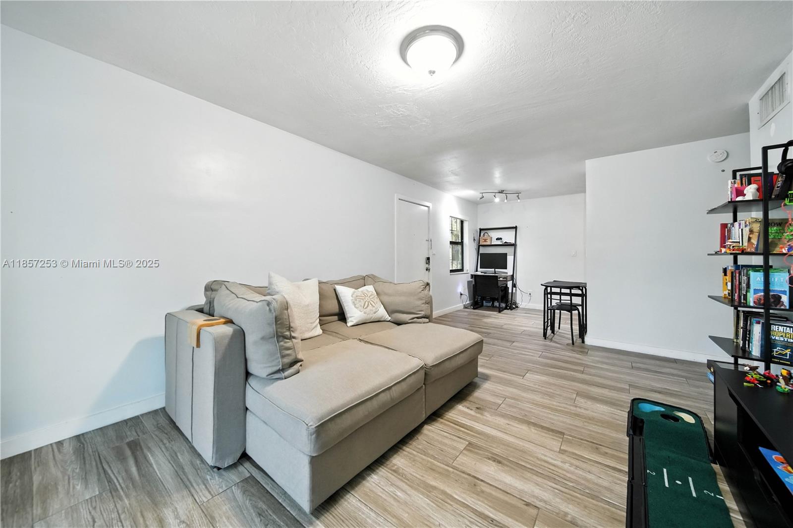 8701 Southwest 141st Street, Unit B1 Miami, FL 33176 - Photo 3 of 22 a living room with furniture and a flat screen tv