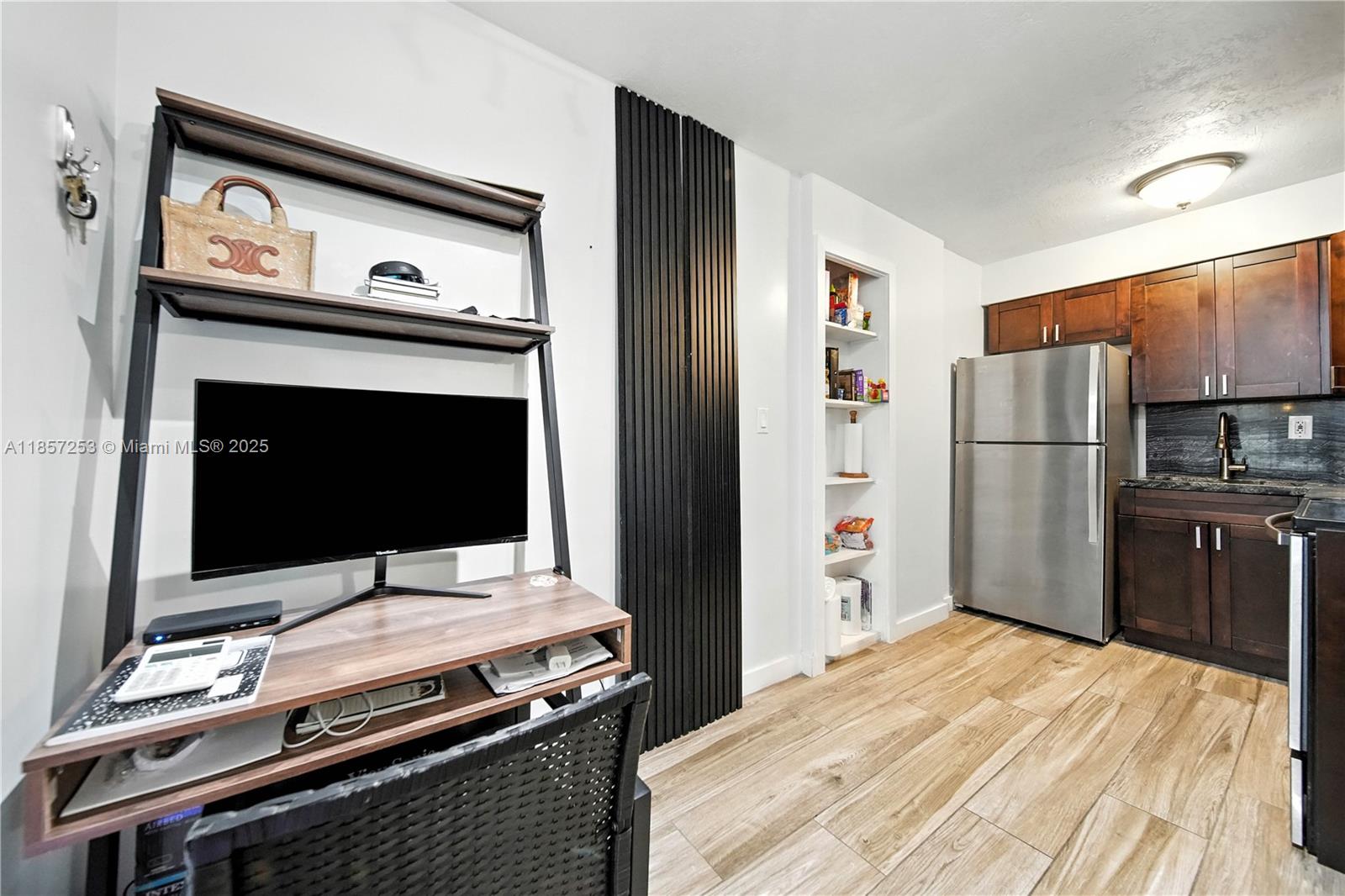 8701 Southwest 141st Street, Unit B1 Miami, FL 33176 - Photo 4 of 22 a kitchen with a refrigerator stove and microwave