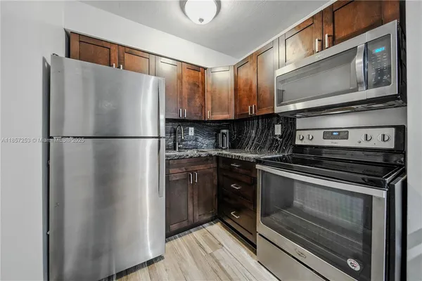 a kitchen with a refrigerator stove and microwave