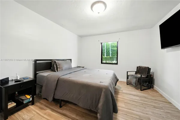 a bedroom with a bed and a television