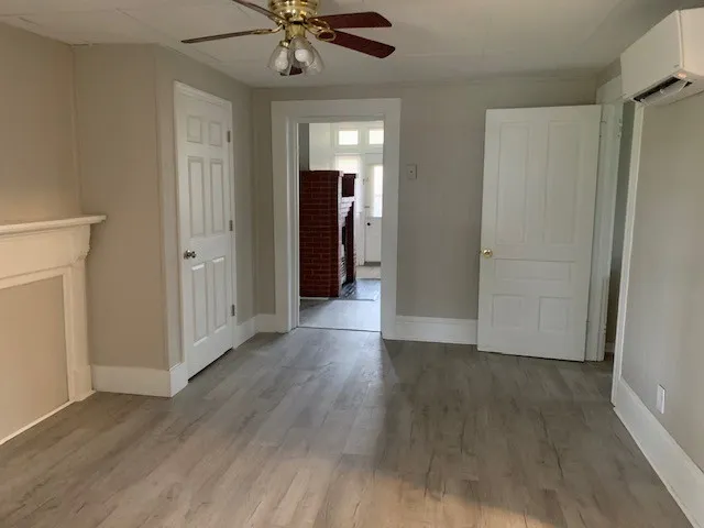 a view of a hallway with wooden floor