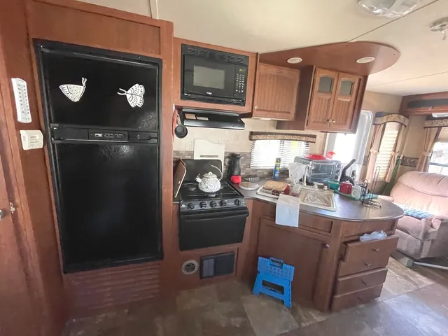 a kitchen with stainless steel appliances granite countertop a refrigerator and stove