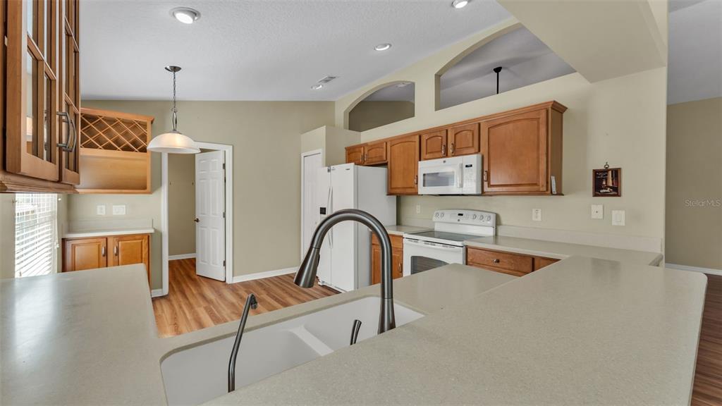 3588 Raleigh Drive Winter Haven, FL 33884 - Photo 12 of 40 a living room with stainless steel appliances kitchen island granite countertop a sink and cabinets